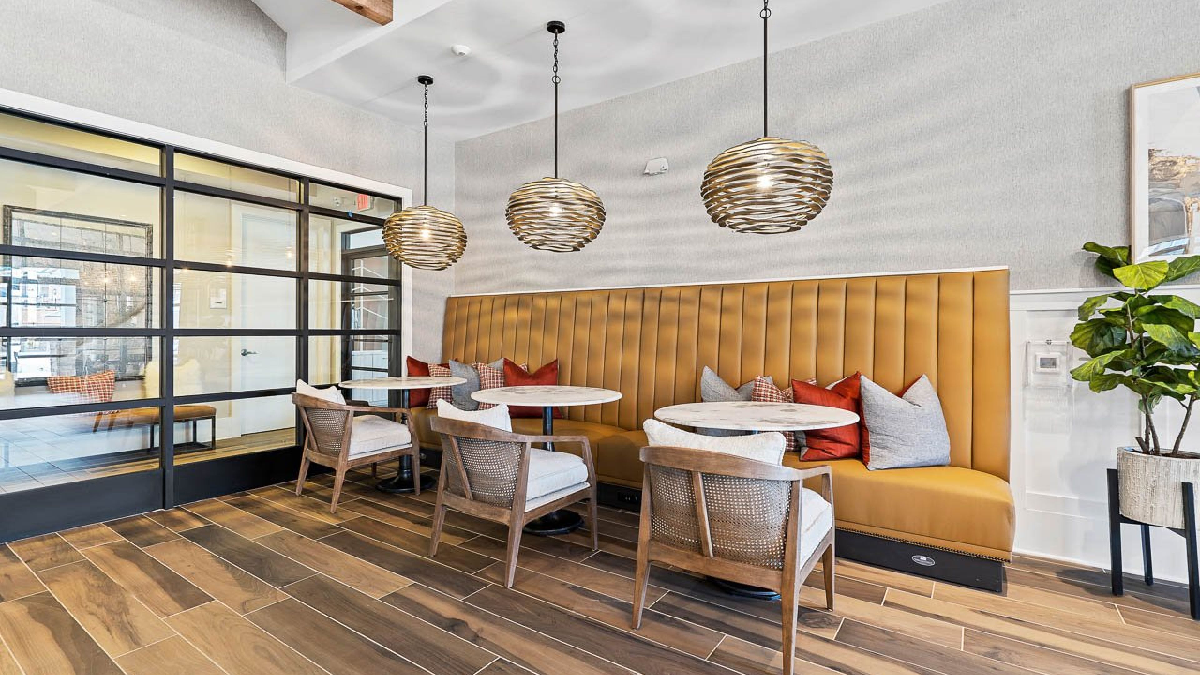Hawthorne Waterstone cyber cafe amenity with booth and chair seating and tables for working remotely