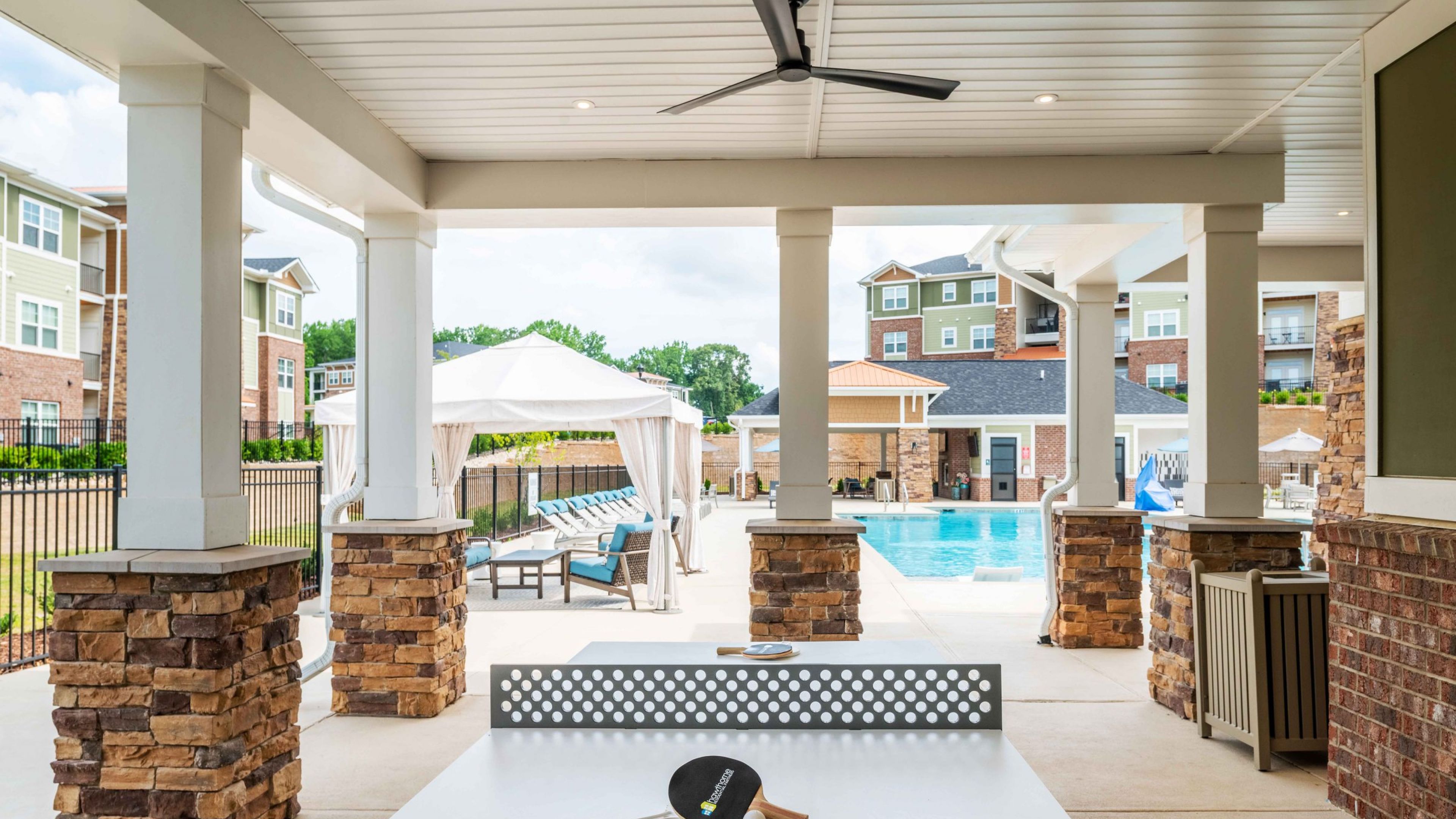 Hawthorne Waterstone outdoor amenity space with ping pong table and poolside cabanas