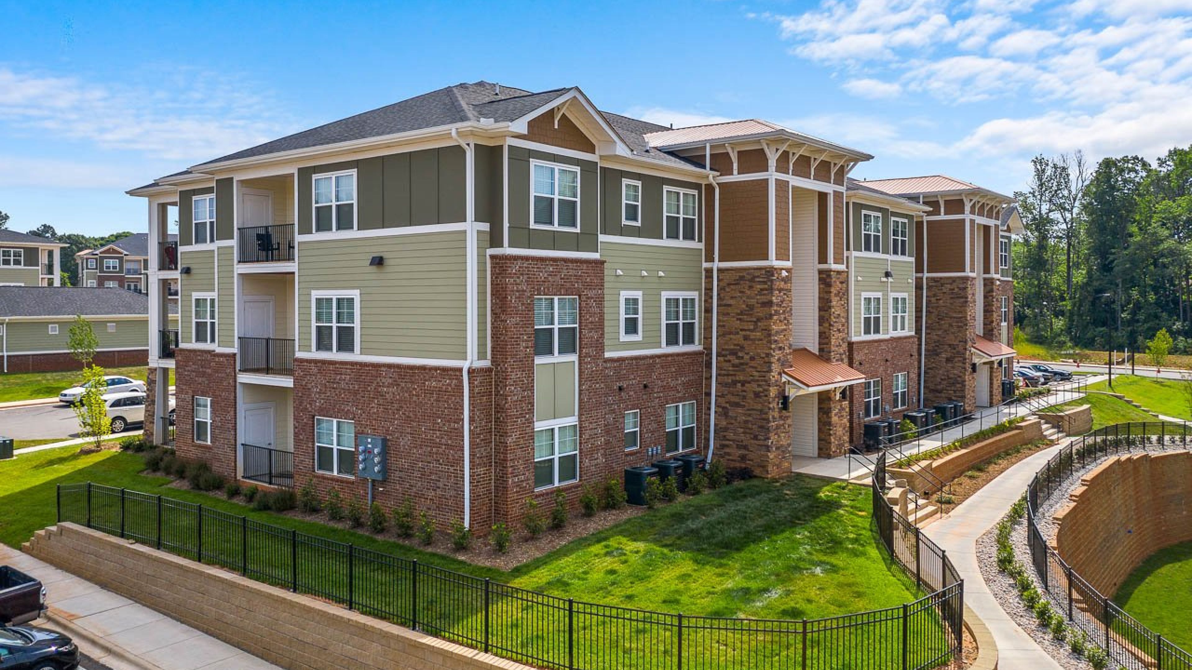 Hawthorne Waterstone exterior view of apartments building and surrounding greenery