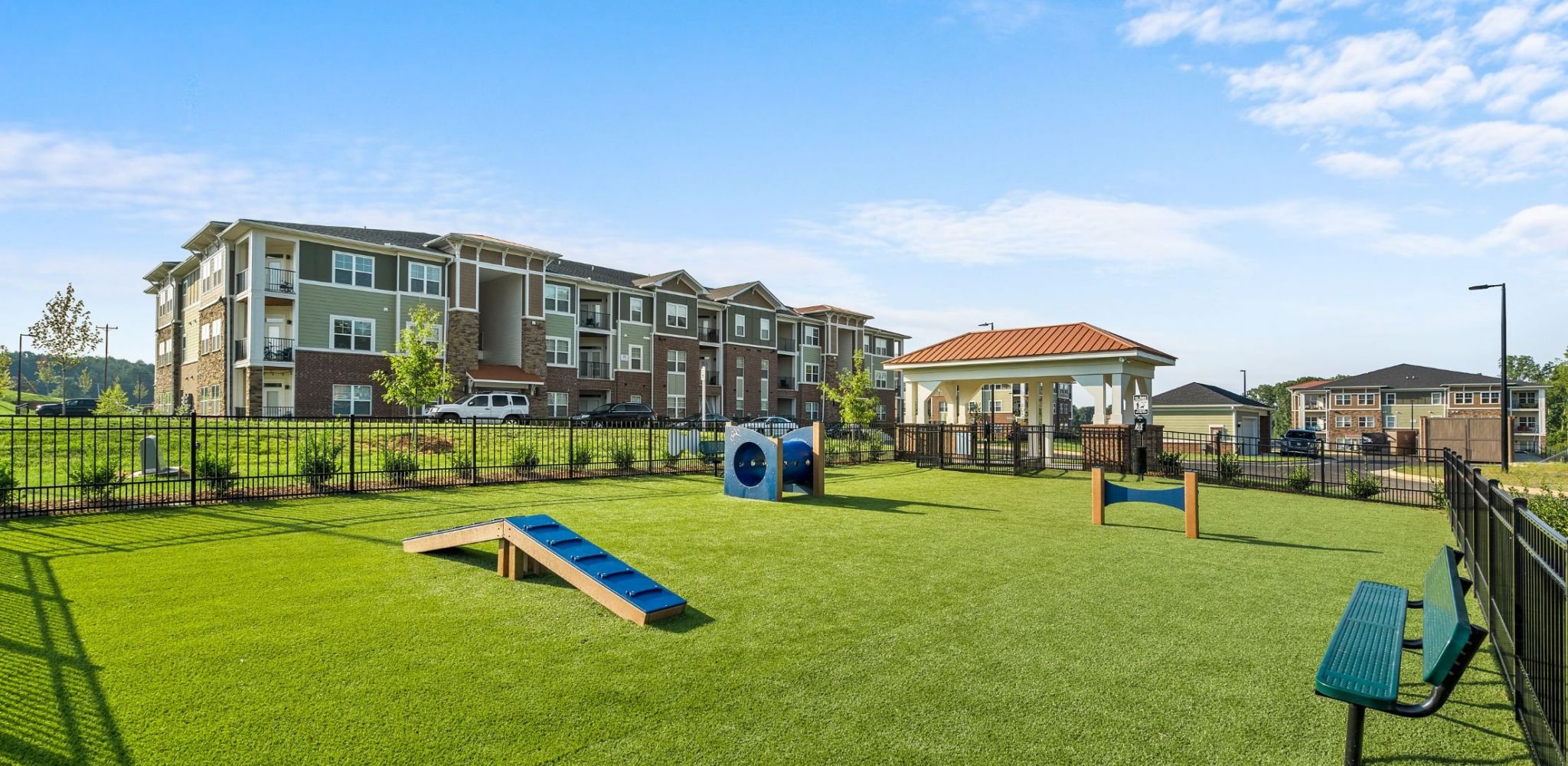 Hawthorne Waterstone large dog park with green grass and agility equipment